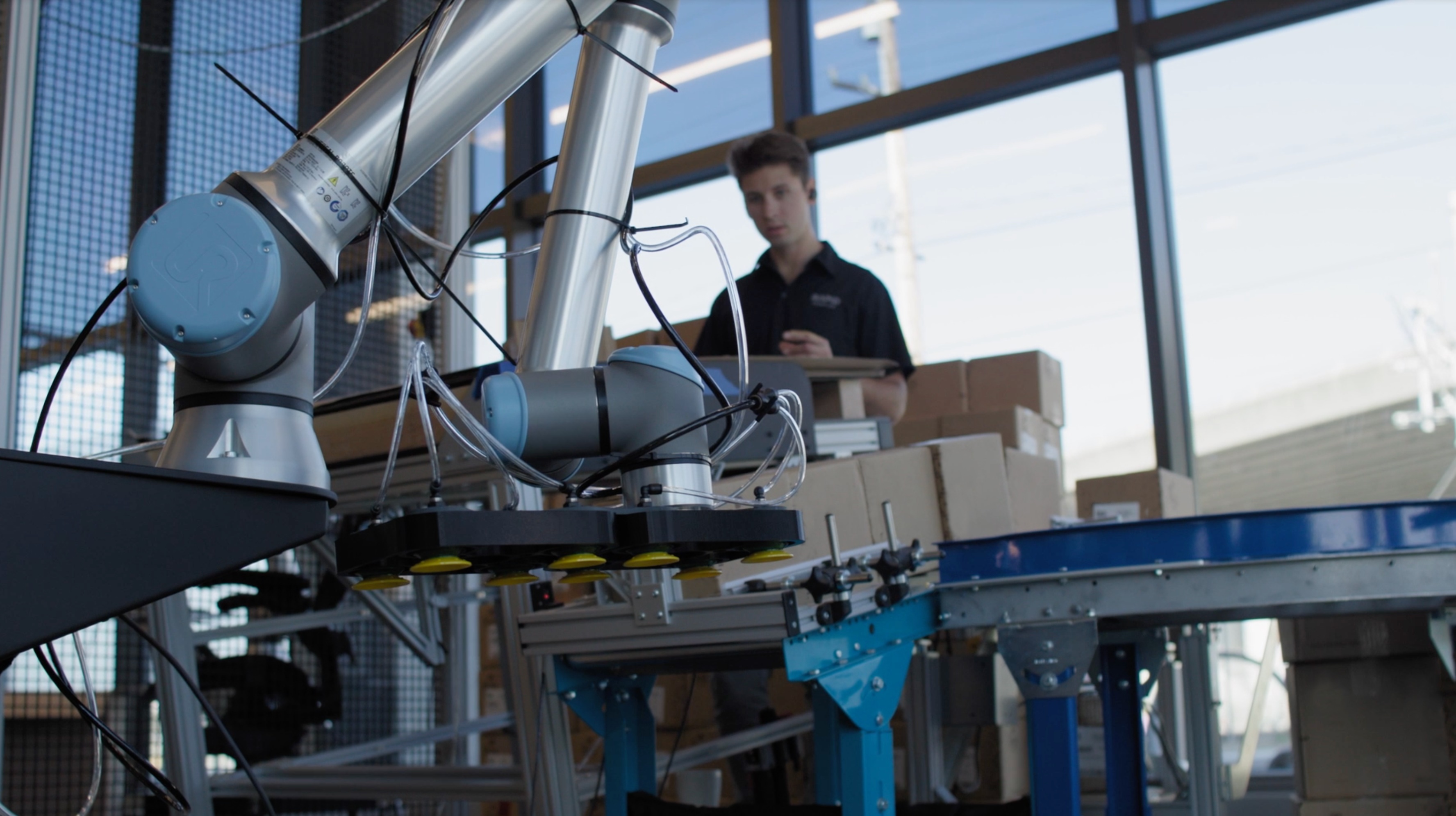 An engineer trains a Universal Robots cobot on a palletizing task.