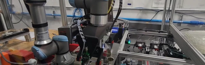 A Universal Robots cobot with a custom end of arm tool removes gates from an injection molded automotive touchscreen.