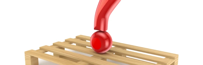 A glossy red query mark atop a wooden pallet.